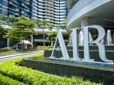 a large metal sign in front of a building at City Comfort Staycation 1BR Air Residences Makati in Manila