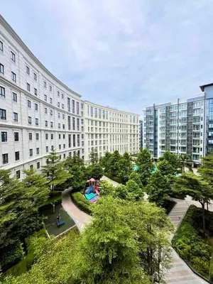 a large building with a park in front of it at Big Studio Unit in Newport near NAIA w Balcony in Manila