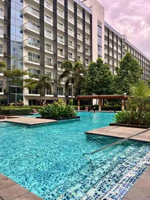 a large swimming pool in front of a building at Big Studio Unit in Newport near NAIA w Balcony in Manila