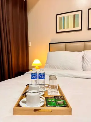 a tray of food on top of a bed at Big Studio Unit in Newport near NAIA w Balcony in Manila
