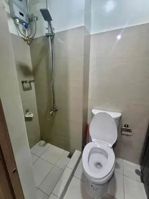 a bathroom with a toilet and a shower at Manial Mall of Asia 1 Bedroom Shore 2 Residence in Manila