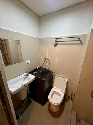 a small bathroom with a toilet and a sink at Staycation ni Gelo in Manila