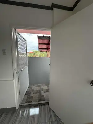 an empty room with a door and a window at Diego Residences in Manila