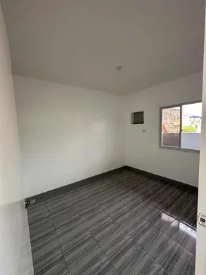 an empty room with white walls and a window at Diego Residences in Manila