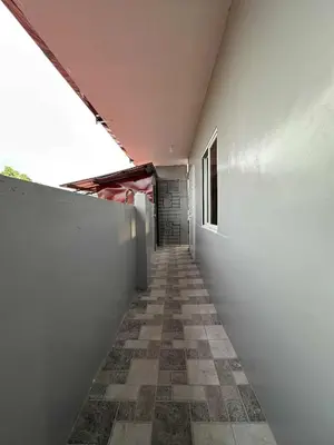 a hallway of a building with a wall and a tile floor at Diego Residences in Manila