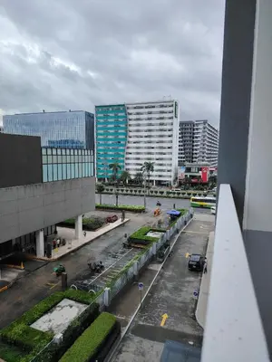 a view of a parking lot in a city with buildings at AteAbyPlace648 in Manila