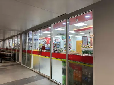 a store aisle with glass doors in a store at AteAbyPlace648 in Manila