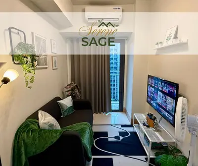 a living room with a couch and a tv at Serene Sage in Manila