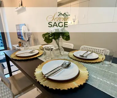 a table with plates and silverware on top of it at Serene Sage in Manila