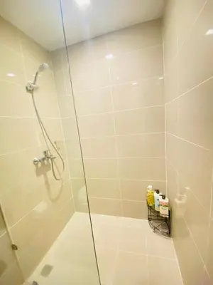 a bathroom with a shower with a glass door at Uptown Parksuites BGC Cosy Hotel Vibe Flat near St Lukes, Uptown Mall, Mitsukoshi and Grand Hyatt in Manila