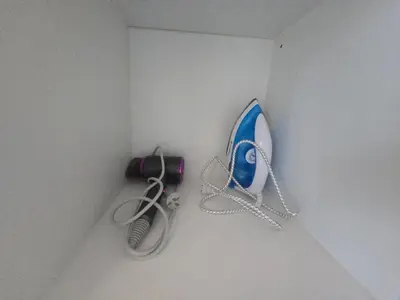 a wall with a hair dryer and a whisk at Uptown Parksuites BGC Cosy Hotel Vibe Flat near St Lukes, Uptown Mall, Mitsukoshi and Grand Hyatt in Manila