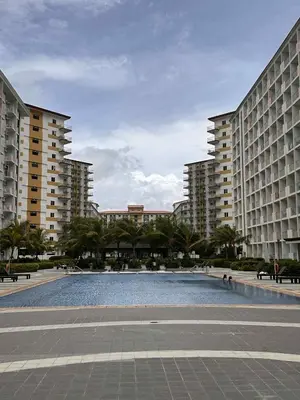 a large pool in the middle of two large buildings at Eu & El Cozy Condo in Manila