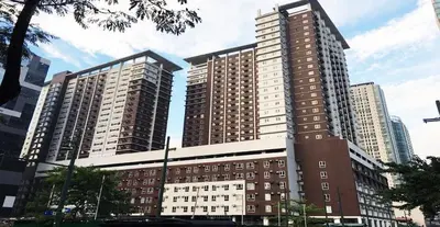 two tall buildings in a city with at unit 129 Studio Type Avida Cityflex BGC in Manila