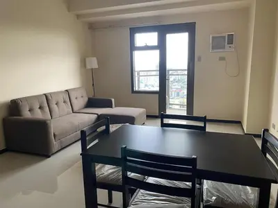 a living room with a table and a couch at The Radiance Manila Bay 1BR in Manila