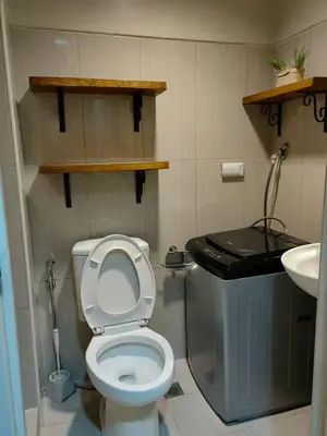 a small bathroom with a toilet and a sink at Apartment Shell Residences near MOA in Manila