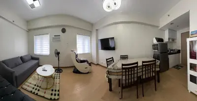 a living room with a couch and a table at G-VibeZzz Staycation in Trece Martires