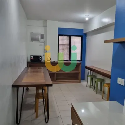 a room with tables and chairs and a window at Woke Coliving Kanlaon in Manila