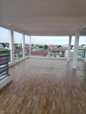an empty room with a wooden floor and white ceilings at Alexander Dones Apartment in Sangley Point Naval Station