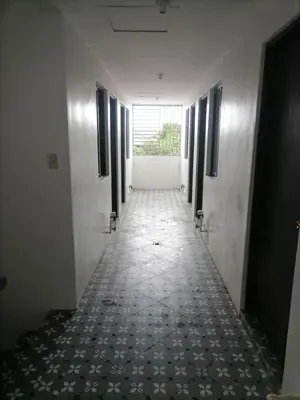 a corridor of an empty room with a corridorngthngthngthngthngthngthngth at Alexander Dones Apartment in Sangley Point Naval Station