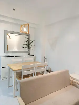 a dining room with a table and a mirror at Friends Zone - 2BR condo unit in Mandaluyong in Manila