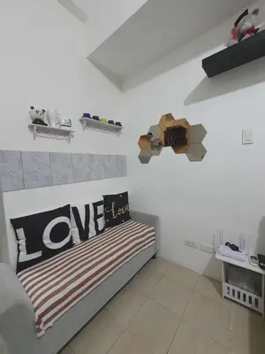 a room with a bed with a love sign on the wall at Doc Odette Studio Staycation in Manila