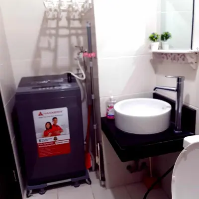 a bathroom with a sink and a shower in it at Doc Odette Studio Staycation in Manila
