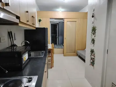 a kitchen with a sink and a counter top at AteAbyPlace830 in Manila