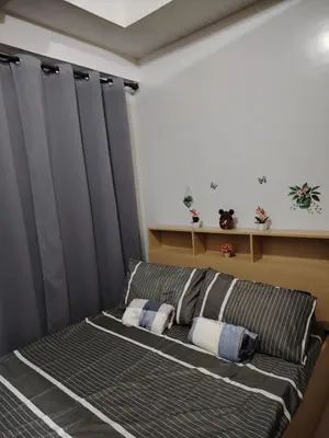 a bed with two pillows on it in a room at AteAbyPlace830 in Manila