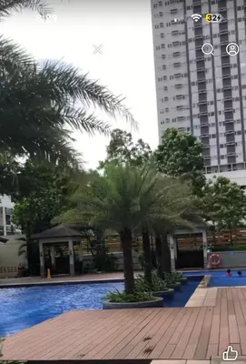 a swimming pool with palm trees and buildings at 1BR LaVerti Cloud Nine Suite Family affordable staycation in Manila