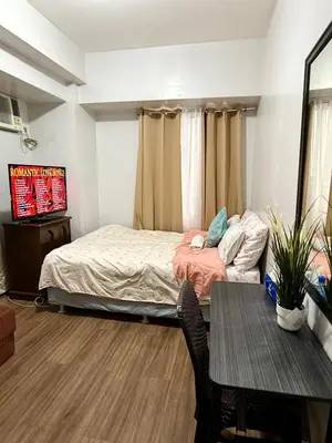 a small bedroom with a bed and a table at 1BR LaVerti Cloud Nine Suite Family Affordable Staycation in Manila