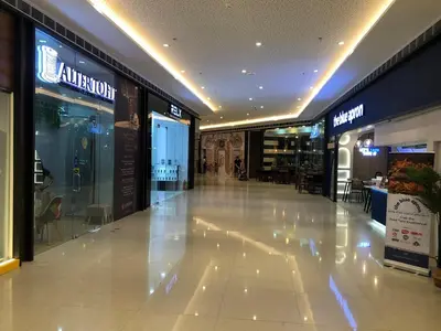 a large shopping mall with a white tile floor at Affordable Condo in Makati Air Residences in Manila