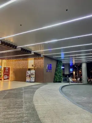 an airport lobby with a christmas tree in the middle at Affordable Condo in Makati Air Residences in Manila