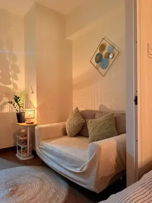 a living room with a couch in a room at Casita avec Amour at Lumiere Residences in Manila