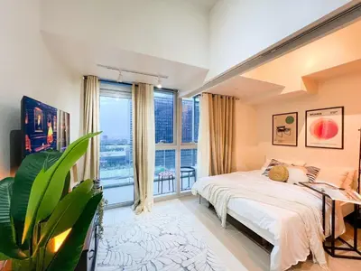 a bedroom with a bed and a large window at Prime BGC 1BR Near Grand Hyatt & Malls #upt215e in Manila