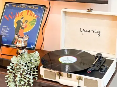 a record player with a vinyl album and a movie at Prime BGC 1BR Near Grand Hyatt & Malls #upt215e in Manila