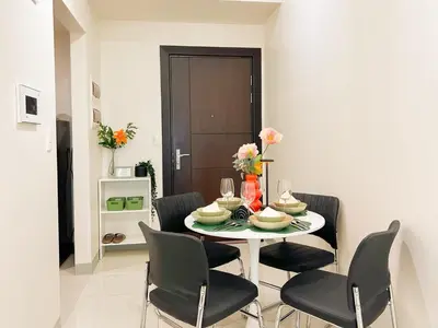 a dining room with a white table and chairs at Prime BGC 1BR Near Grand Hyatt & Malls #upt215e in Manila