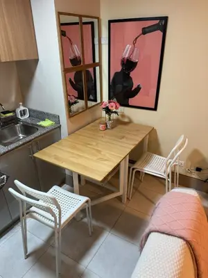 a kitchen with a table and chairs and a sink at Family Comfort Zone Staycation at Greenhills in Manila