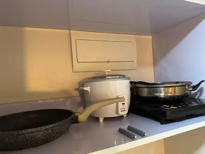 a kitchen with a mixer and a pot on a stove at Family Comfort Zone Staycation at Greenhills in Manila