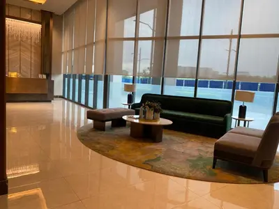 a lobby with a couch and a table and chairs at Gentry Manor 1BR with Balcony Near Okada - 6A in Manila