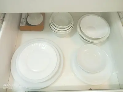 a group of white plates in a drawer at Casa azure by B&M STAYCATION at Paranque in Manila