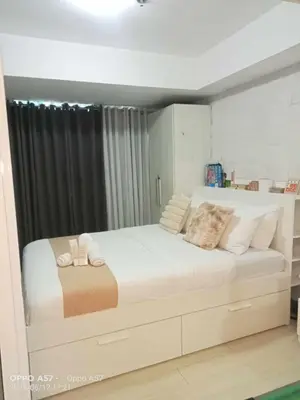a bedroom with a large white bed with pillows at Casa azure by B&M STAYCATION at Paranque in Manila