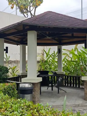 a wooden pavilion with a picnic table in a garden at Condo Unit, 2 Beds, Wi-fi, Free Amenities in Manila