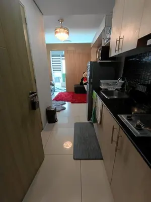 a kitchen with a sink and a counter top at Breeze Residences Condos in Manila