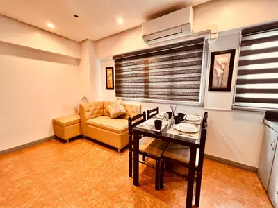 a living room with a couch and a table at G's Bnb in Manila