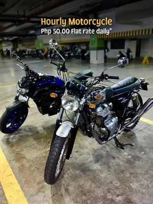 a blue motorcycle parked in a parking lot at 2 Bedroom Unit with Queen-sized Beds near NAIA T3 in Manila