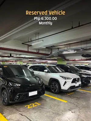 a parking lot with several parked cars in it at 2 Bedroom Unit with Queen-sized Beds near NAIA T3 in Manila