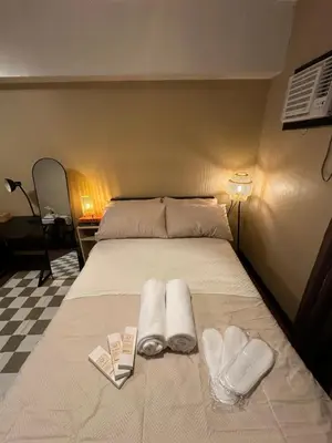 a bed with two white towels and two hearts at La Verti Residences Pasay City in Manila