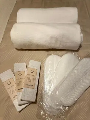 a table with towels and a glass vase and towels at La Verti Residences Pasay City in Manila