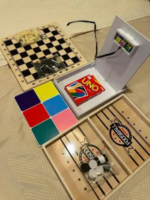 a table with a laptop and a chess board at La Verti Residences Pasay City in Manila