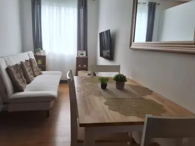 a living room with a table and a couch at The Dwelling Place at Metrotowne Las Pinas in Manila